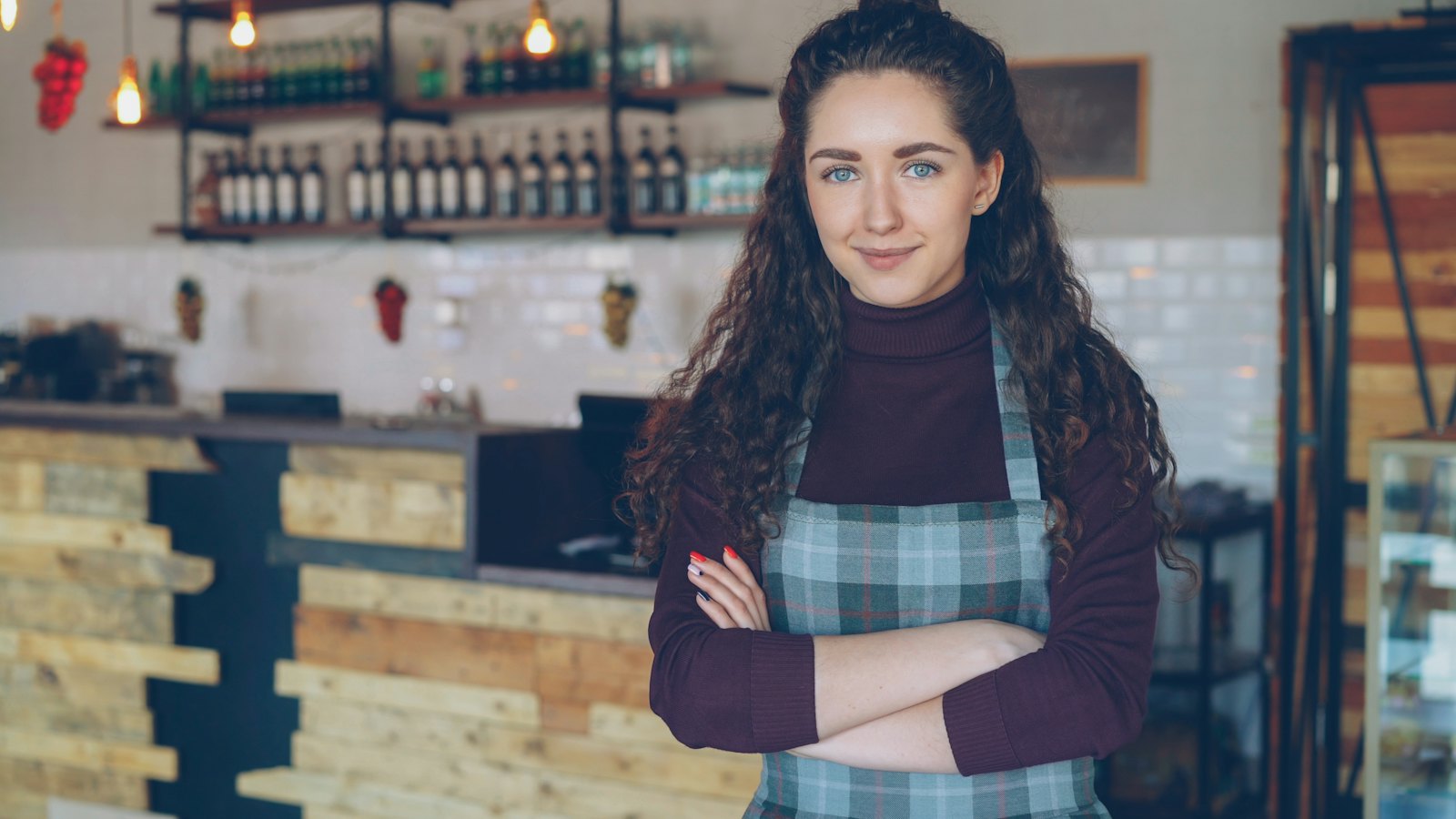 A cafe owner standing in her shop