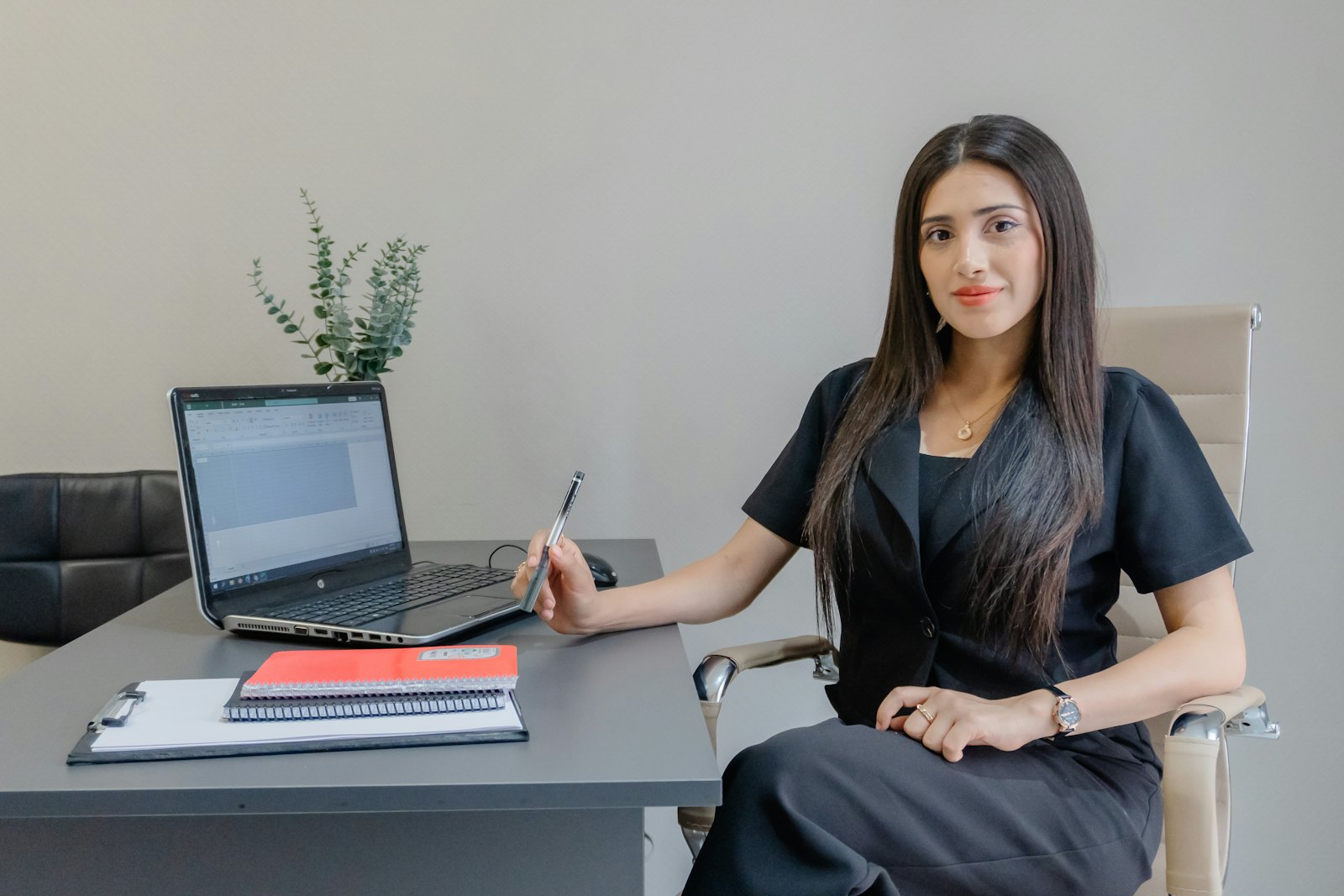 A professional at her desk with a laptop