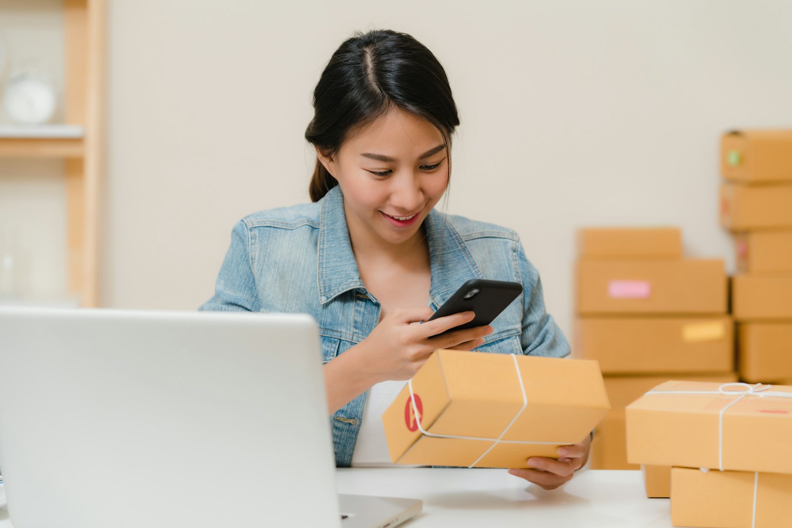 A business owner checking an order beside packed boxes