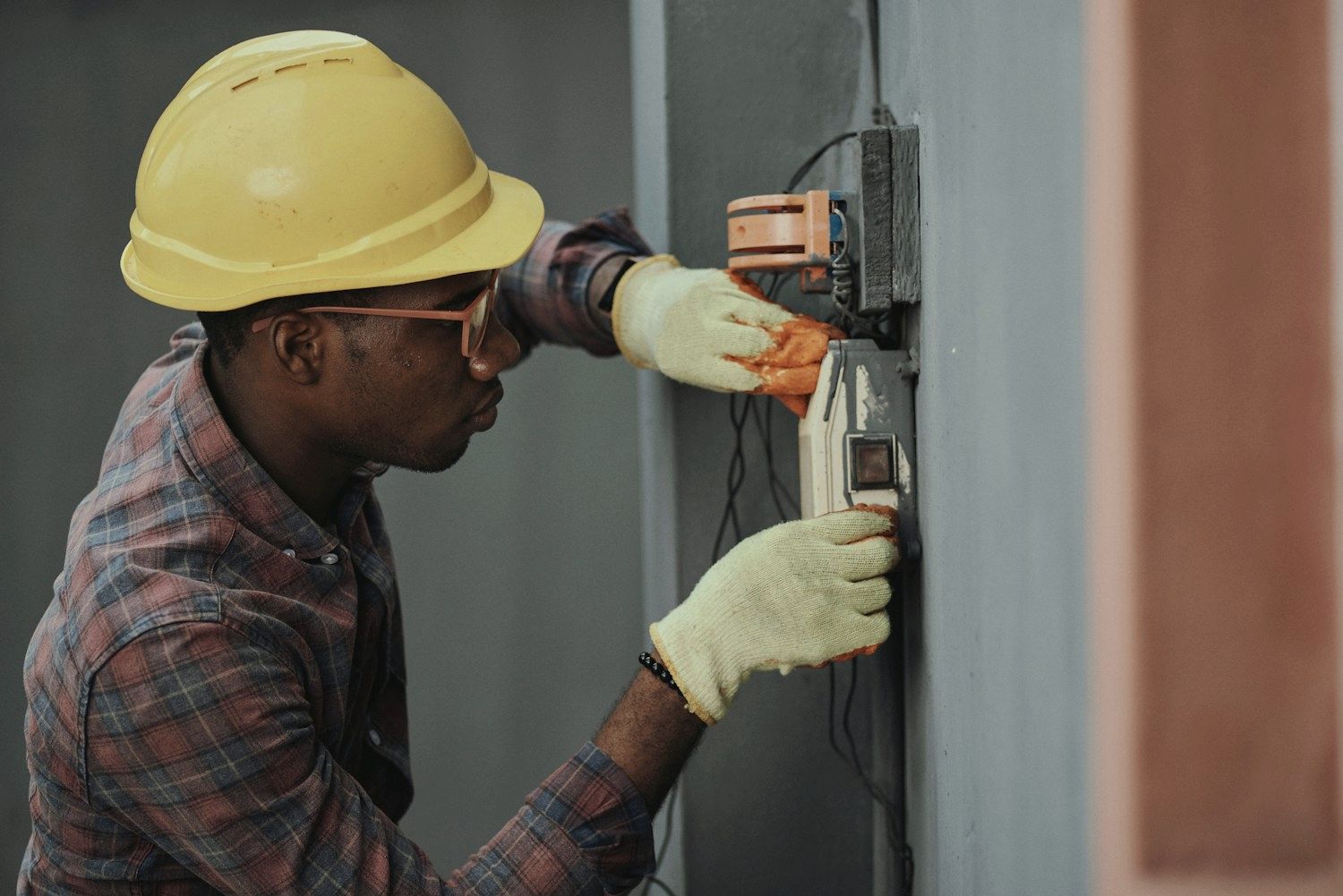 An electrician working on a switchboard